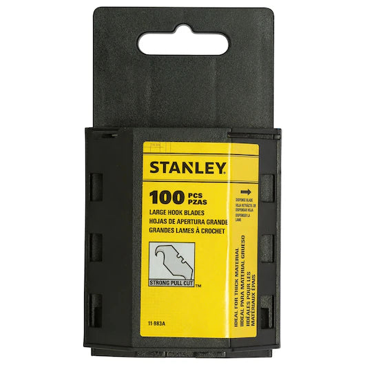 A black plastic case with a yellow label holds 100 Stanley large hook knife blades (19mm x 50mm) for carpet cutting. The label displays the Stanley logo, English and Spanish product info, and a diagram of these heavy-duty replacement blades.